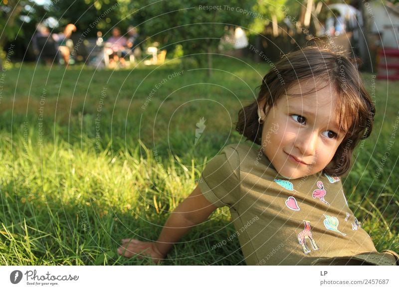Littel girl sitting on grass looking curious Lifestyle Beautiful Harmonious Well-being Contentment Senses Relaxation Calm Leisure and hobbies Playing