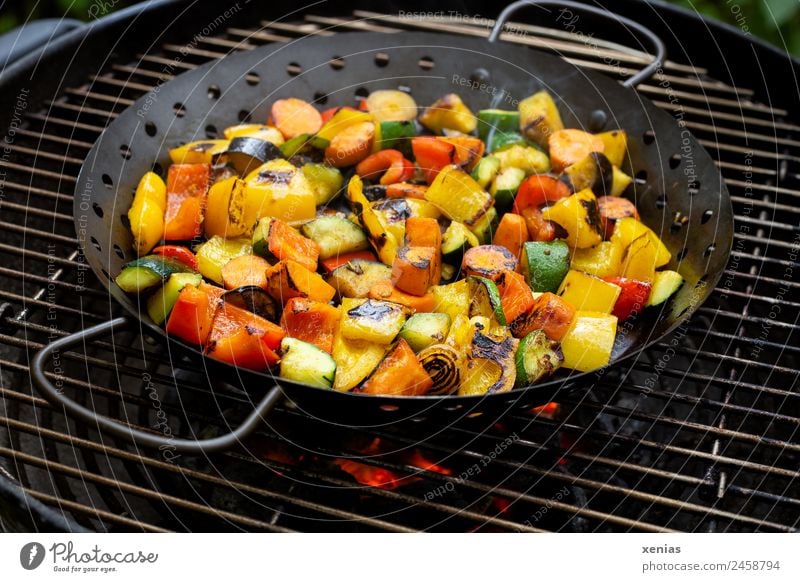 Pan with vegetables stands on grill with glowing coals Vegetable BBQ Pepper Embers Carrot Zucchini grill pan Onion Nutrition Lunch Dinner Organic produce
