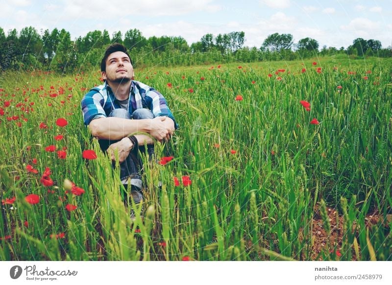 Young man alone in a field of green wheat Lifestyle Style Healthy Wellness Harmonious Well-being Senses Relaxation Adventure Far-off places Freedom Human being