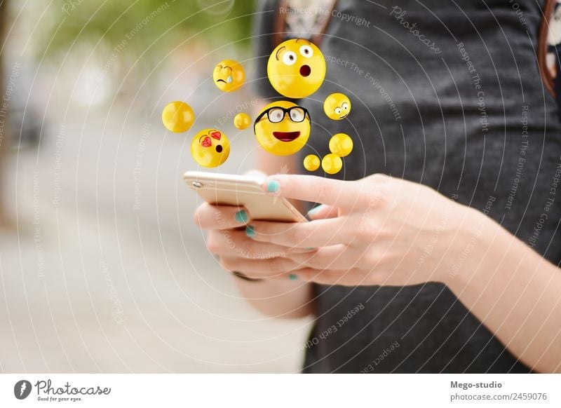 young woman using smartphone sending emojis. Lifestyle Happy Face Telephone PDA Screen Technology Internet Human being Woman Adults Man Hand Funny Modern Smart