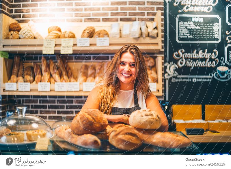 Woman sells in bakery. Bread Shopping Profession Business Human being Adults Smiling Sell Fresh Small Arrangement Retail sector Bread basket Hold Indulgence