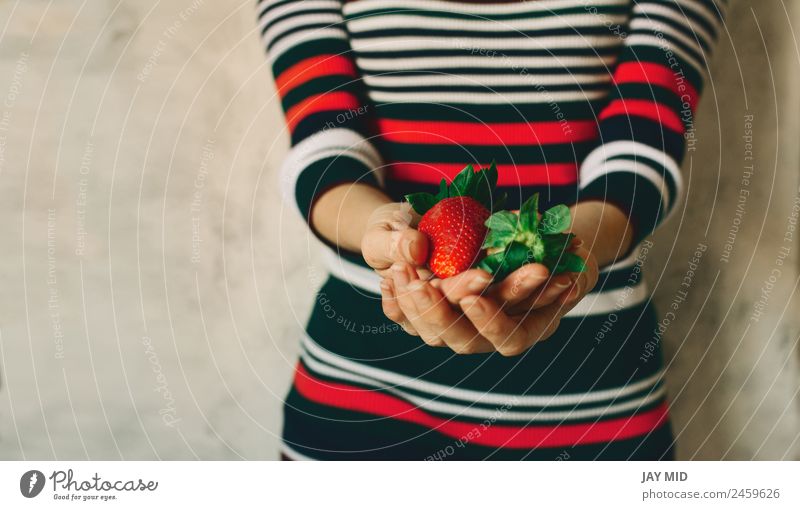 Woman holds strawberries in her hands Food Fruit Eating Breakfast Organic produce Vegetarian diet Diet Human being Feminine Adults Hand 1 Nature Leaf Dress