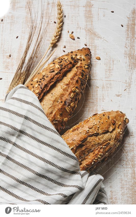 rustic seeded bread, wrapped in striped fabric Food Bread Breakfast Organic produce Diet Group Fresh Brown White Tradition breads loaf of bread corn