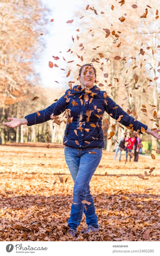 Woman in colorfull forest in autumn Lifestyle Joy Happy Beautiful Relaxation Playing Freedom Success Human being Adults Arm Nature Autumn Tree Leaf Park Forest