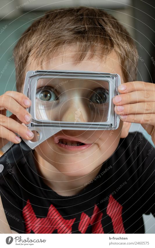 Child with reading magnifier Kindergarten School Office Face Eyes 3 - 8 years Infancy Glass Observe Discover To hold on Happiness Curiosity Optimism Adventure