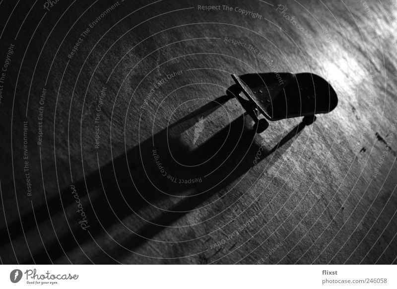 Night session Skateboard Eerie Shadow play Roll Black & white photo Exterior shot Copy Space left Copy Space bottom Evening Artificial light Contrast Back-light