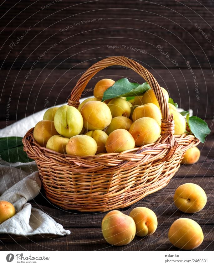 Ripe apricots in a brown wicker basket Fruit Nutrition Vegetarian diet Diet Table Eating Fresh Natural Juicy Brown Yellow Colour Basket agriculture Apricot