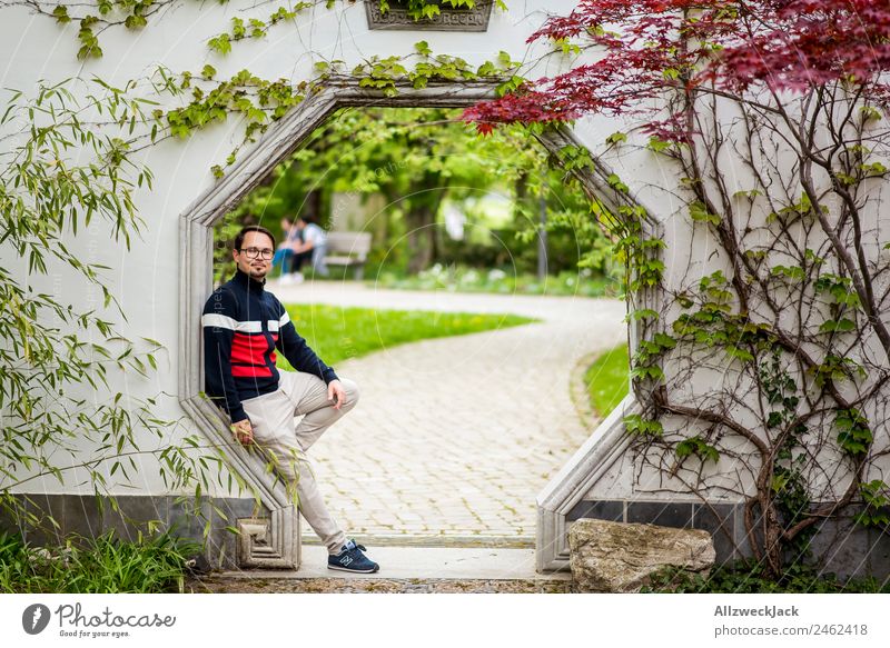 Portrait of a young man in a passageway Day 1 Person Young man Portrait photograph Germany Berlin Capital city Nature Maple tree Maple leaf Asia Japanese garden