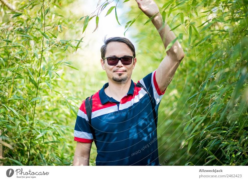 Portrait of a young man in the bamboo jungle Portrait photograph Young man 1 Person Sunglasses Green Nature Day Bamboo Bushes Leaf Forest Virgin forest