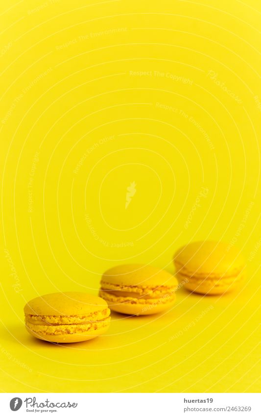 Sweet macarons with yellow background Food Cake Dessert Candy Nutrition Breakfast Banquet Art Artist Yellow Happiness Appetite Colour Macaron isolated sweet