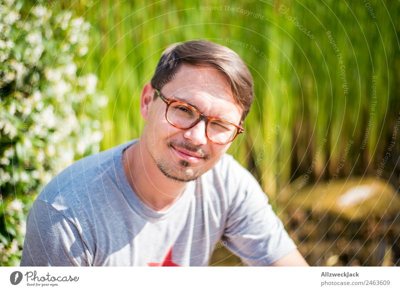 young man with glasses smiles in camera 1 Person Young man Portrait photograph Eyeglasses Person wearing glasses Smiling Congenial Happiness Friendliness Nature