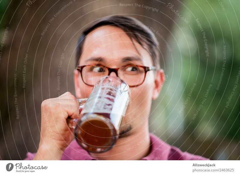 Portrait of a young man with a beer glass in his hand Portrait photograph 1 Person Young man Upper body Looking Inattentive drinking contest Beer glass Beer mug