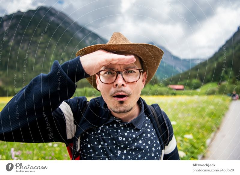 Man with a hat on the lookout Summer Beautiful weather Nature Clouds Mountain Alps Federal State of Tyrol Grass Meadow Green Juicy Alpine pasture Detail