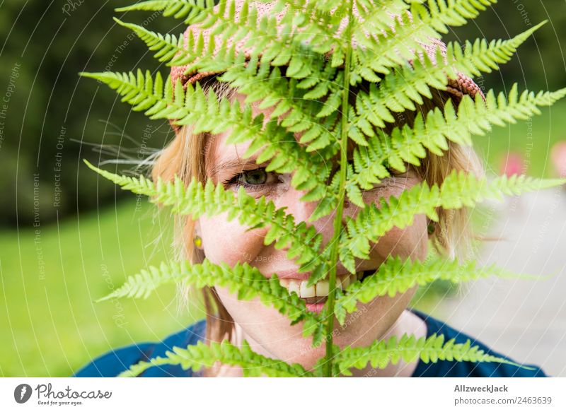 Portrait of a young woman with fern in her face Day Beautiful weather Nature Green Tree Forest Mountain Idyll Vacation & Travel Travel photography Hiking