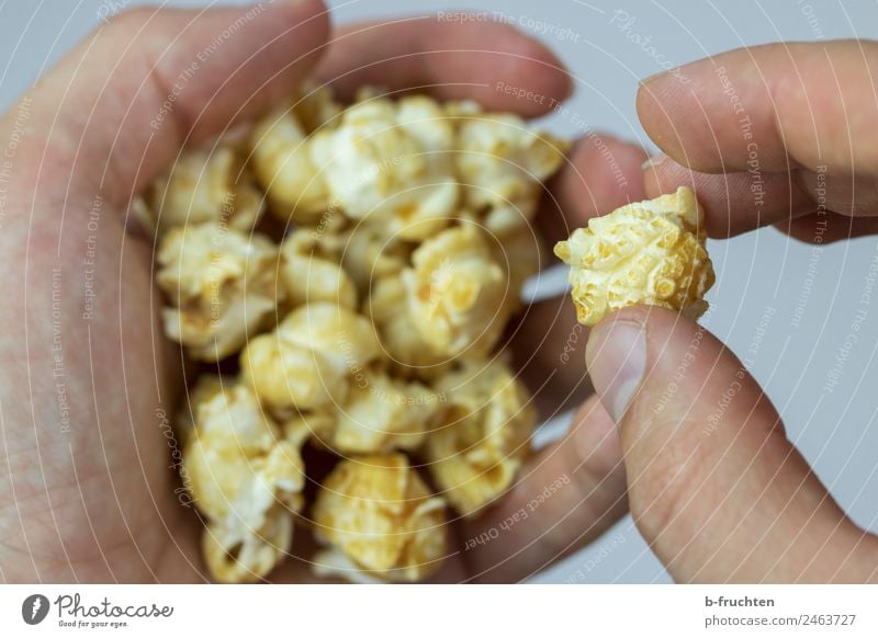 PopCorn Grain Candy Hand Fingers Eating To hold on Popcorn Entertainment Unhealthy Cinema Snack Colour photo Interior shot Studio shot Close-up