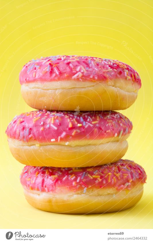 Pink donuts Food Roll Dessert Candy Breakfast snack Eating Fresh Good Sweet Yellow Donut Sugar Dough Hold Baked goods Fast food Colour photo Studio shot