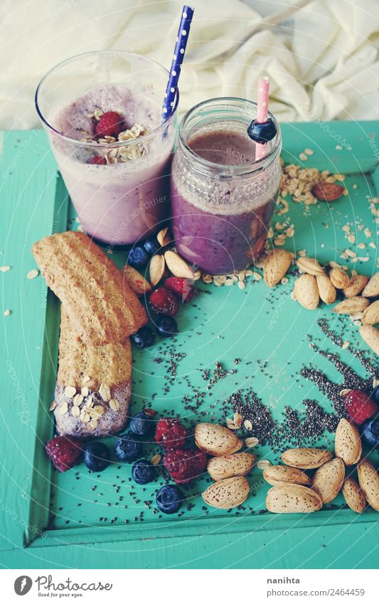 Healthy breakfast with smoothies, berries and grains Food Fruit Grain Dough Baked goods Raspberry Blueberry Almond chia Oat flakes Cookie Strawberry shake