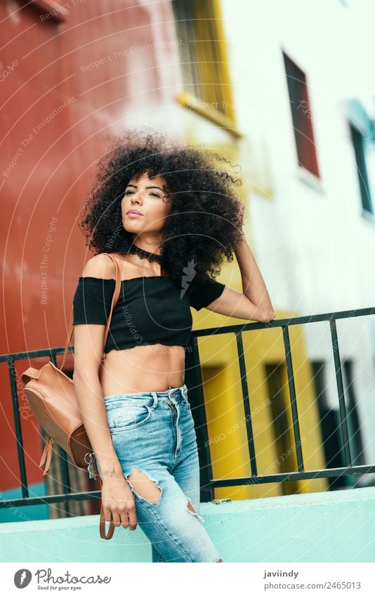 Young woman with curly hair near a modern colorful building Lifestyle Style Happy Beautiful Hair and hairstyles Face Human being Feminine Youth (Young adults)