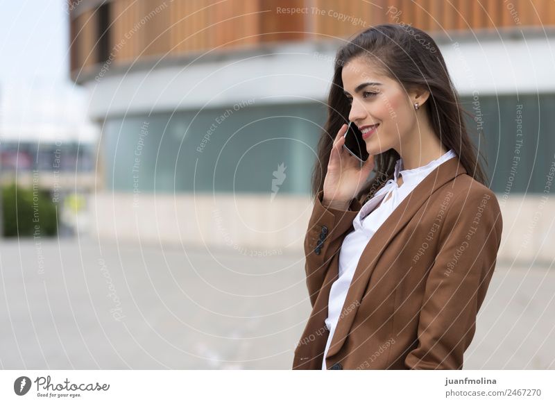 Woman call business happy Happy Beautiful Business To talk Telephone PDA Technology Human being Adults 18 - 30 years Youth (Young adults) Town Street Suit