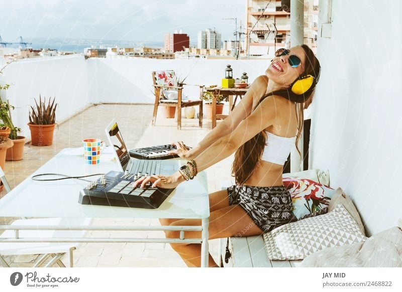 woman sitting with mixing table, producing music Lifestyle Summer Table Music Disc jockey Headset PDA Computer Notebook Keyboard Technology Feminine Woman