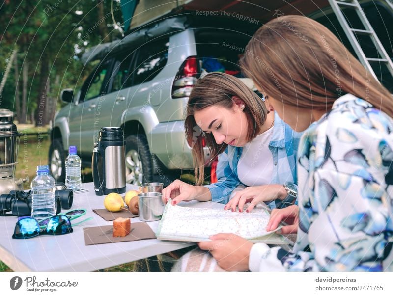 Young women looking road map with 4x4 on background Breakfast Coffee Lifestyle Joy Relaxation Leisure and hobbies Vacation & Travel Trip Adventure Camping