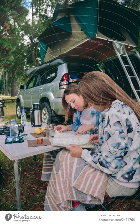 Young women looking road map with vehicle on background Breakfast Coffee Lifestyle Joy Relaxation Leisure and hobbies Vacation & Travel Trip Adventure Camping