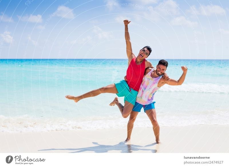 Two men celebrating with pride month on the beach Lifestyle Style Joy Vacation & Travel Tourism Sun Beach Homosexual Man Adults Friendship Couple Sand Fashion