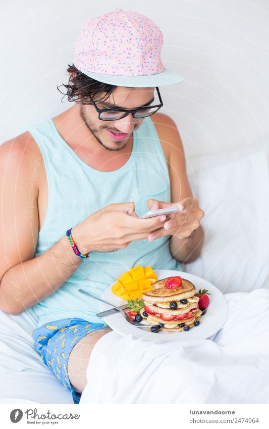 Millenial having breakfast in bed and taking pictures Dessert Breakfast Lunch Plate Lifestyle Homosexual Man Adults Cap Delicious White app Berries blogger Dish