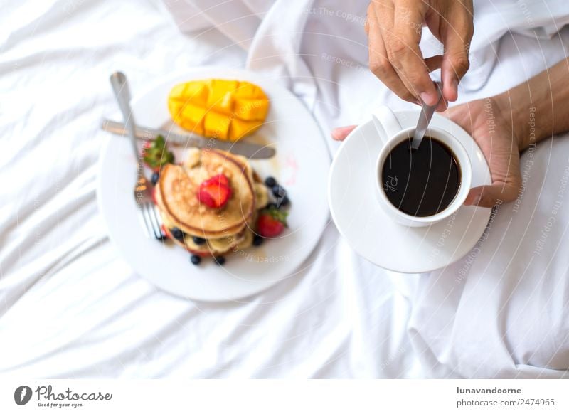 Hotcakes with fruit and coffee in bed Dessert Breakfast Lunch Coffee Plate Man Adults Hand Delicious White Berries blogger colorful Dish food healthy Home-made