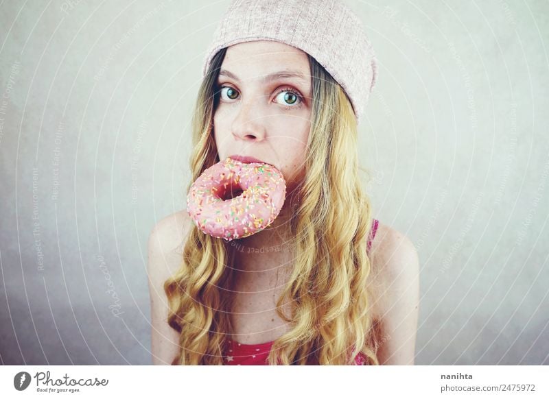 Young funny woman eating a donut Food Dessert Candy Donut Nutrition Eating Fast food Lifestyle Style Beautiful Hair and hairstyles Face Human being Feminine