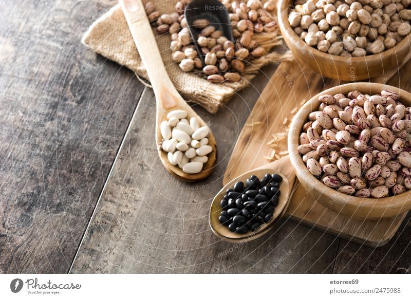 Uncooked assorted legumes in wooden bowl Food Grain Nutrition Organic produce Vegetarian diet Diet Bowl Spoon Natural Brown Legume Beans Chickpeas