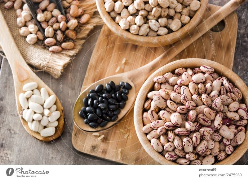 Uncooked assorted legumes in wood Food Grain Nutrition Organic produce Vegetarian diet Diet Bowl Spoon Natural Brown Legume Beans Chickpeas Food photograph