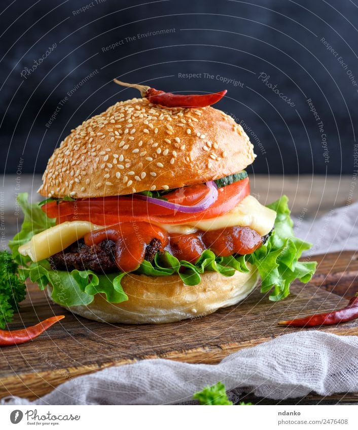 hamburger with a meatball and vegetables Meat Cheese Vegetable Bread Roll Lunch Fast food Table Restaurant Wood Eating Fresh Large Delicious Green Red Hamburger