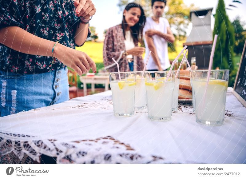 Friends at table with fresh lemonade having fun Beverage Drinking Lemonade Straw Lifestyle Joy Happy Leisure and hobbies Summer Garden Table To talk Woman
