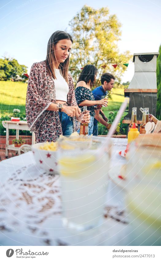 Woman opening beer bottle in summer barbecue Eating Lunch Beverage Lemonade Alcoholic drinks Beer Bottle Straw Lifestyle Joy Happy Leisure and hobbies Summer