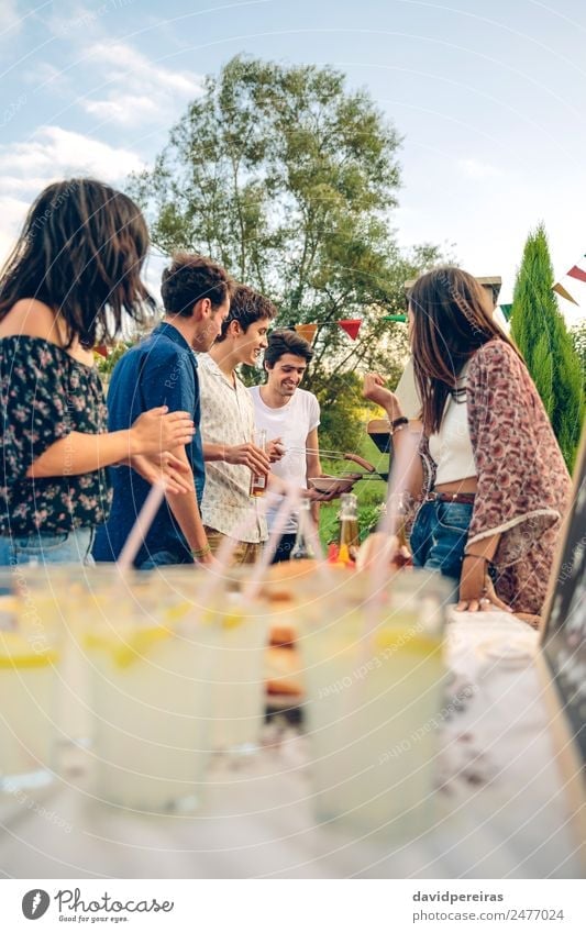 Group of friends having fun in a summer barbecue Meat Sausage Lunch Lemonade Alcoholic drinks Beer Straw Lifestyle Joy Happy Leisure and hobbies Summer Garden