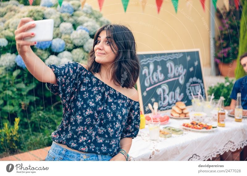 Funny young woman taking a selfie with smartphone Lunch Alcoholic drinks Beer Lifestyle Joy Happy Leisure and hobbies Summer Garden Table Blackboard Telephone
