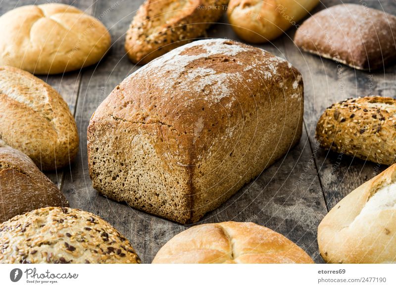 Mixed bread on wooden table Bread Cereal Food Healthy Eating Food photograph Flour Home-made Breakfast Brown Dinner Bakery Toast Nutrition Organic Consistency