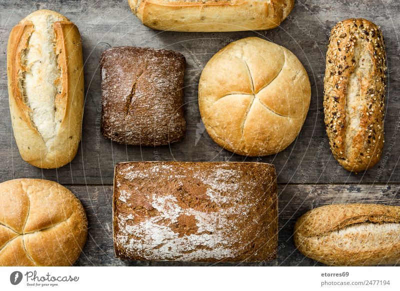 Assorted breads Food Bread Good Dough Exceptional Cereal Wooden table Bird's-eye view Healthy Flour Baked goods Home-made Colour photo Studio shot
