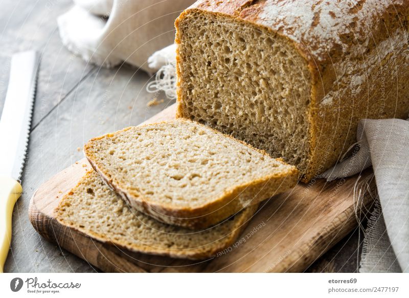 Rustic bread on wooden table Bread Cereal Food Healthy Eating Food photograph Flour Home-made Breakfast Brown Dinner Bakery Toast Nutrition Organic Consistency