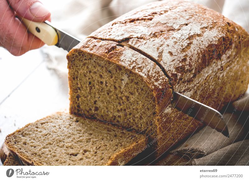 Man cutting bread Food Bread Fresh Healthy Brown Hand Knives Dough Flour Cutting tool Home-made Baked dish Snack Sliced Colour photo Studio shot