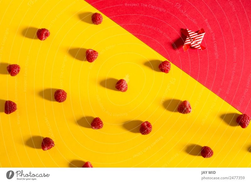 Fresh raspberries on yellow and red background Fruit Dessert Nutrition Vegetarian diet Diet Bowl Summer Nature Delicious Natural Juicy Yellow Red Colour