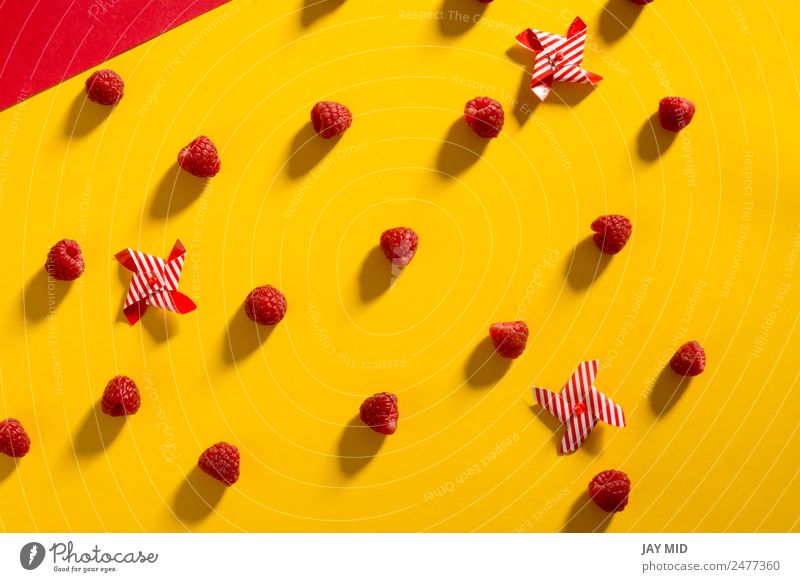 Fresh raspberries on yellow and red background Food Fruit Nutrition Summer Healthy Yellow Red Colour photo Deserted