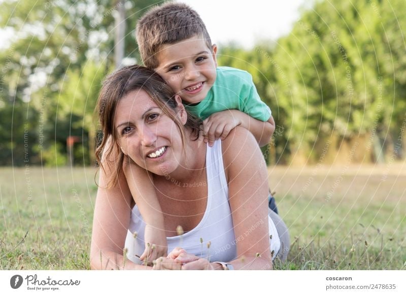 Mother and son lying on the grass Lifestyle Joy Happy Beautiful Leisure and hobbies Vacation & Travel Summer Child Human being Baby Toddler Boy (child) Woman