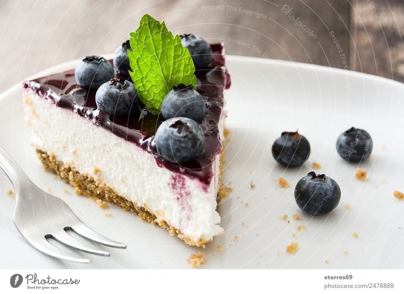 Piece of blueberry cheesecake on wooden table Cheese Cheese slice Blueberry Baked goods Cake Dessert Fruit Sweet Candy Food Healthy Eating Food photograph