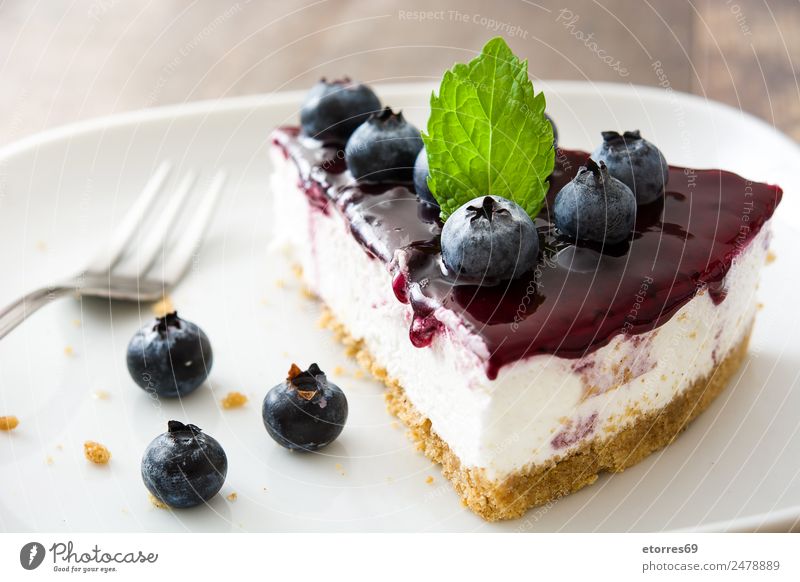 Piece of blueberry cheesecake on wooden table Cheese Cheese slice Blueberry Baked goods Cake Dessert Fruit Sweet Candy Food Healthy Eating Food photograph