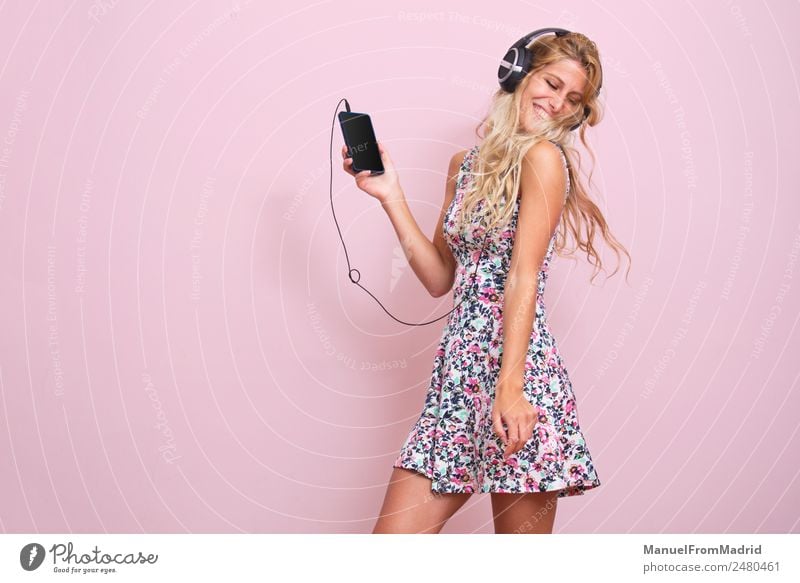 Young woman listening to music Lifestyle Happy Beautiful Music Dance Telephone Youth (Young adults) Woman Adults Body 18 - 30 years Blonde Listening Smiling