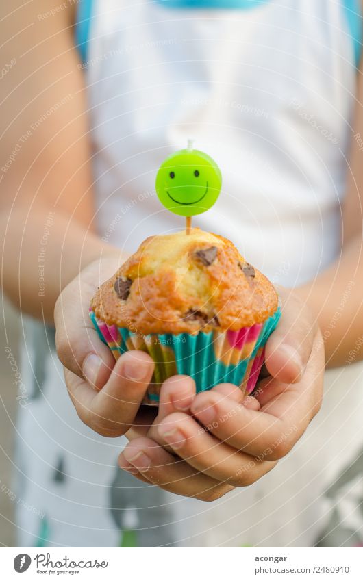 Cupcake and candle smiling in the hands of a child. Food Dessert Happy Table Birthday Child Gastronomy Boy (child) Hand 1 Human being Paper Candle Smiling
