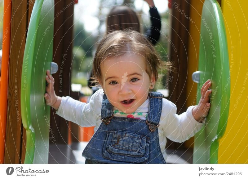 Happy little girl playing in a urban playground. Lifestyle Joy Beautiful Leisure and hobbies Playing Summer Climbing Mountaineering Child Human being Baby Girl