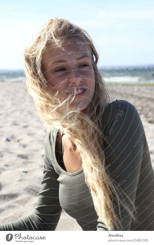 Portrait of a young woman on a windy beach Lifestyle Happy pretty Harmonious Trip Young woman Youth (Young adults) 18 - 30 years Adults Nature Landscape Summer